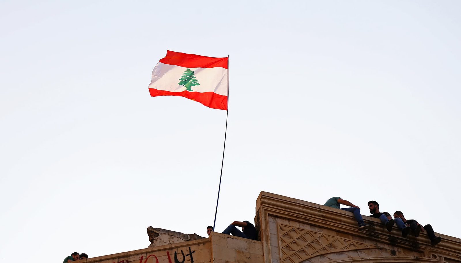What's happening in Lebanon? And How Can We Help? flag of us a on top of building
