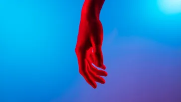 persons left hand on blue surface