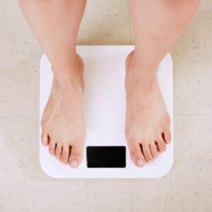 Post-Eid Food Detox: How to Recover After Days of Overeating person standing on white digital bathroom scale