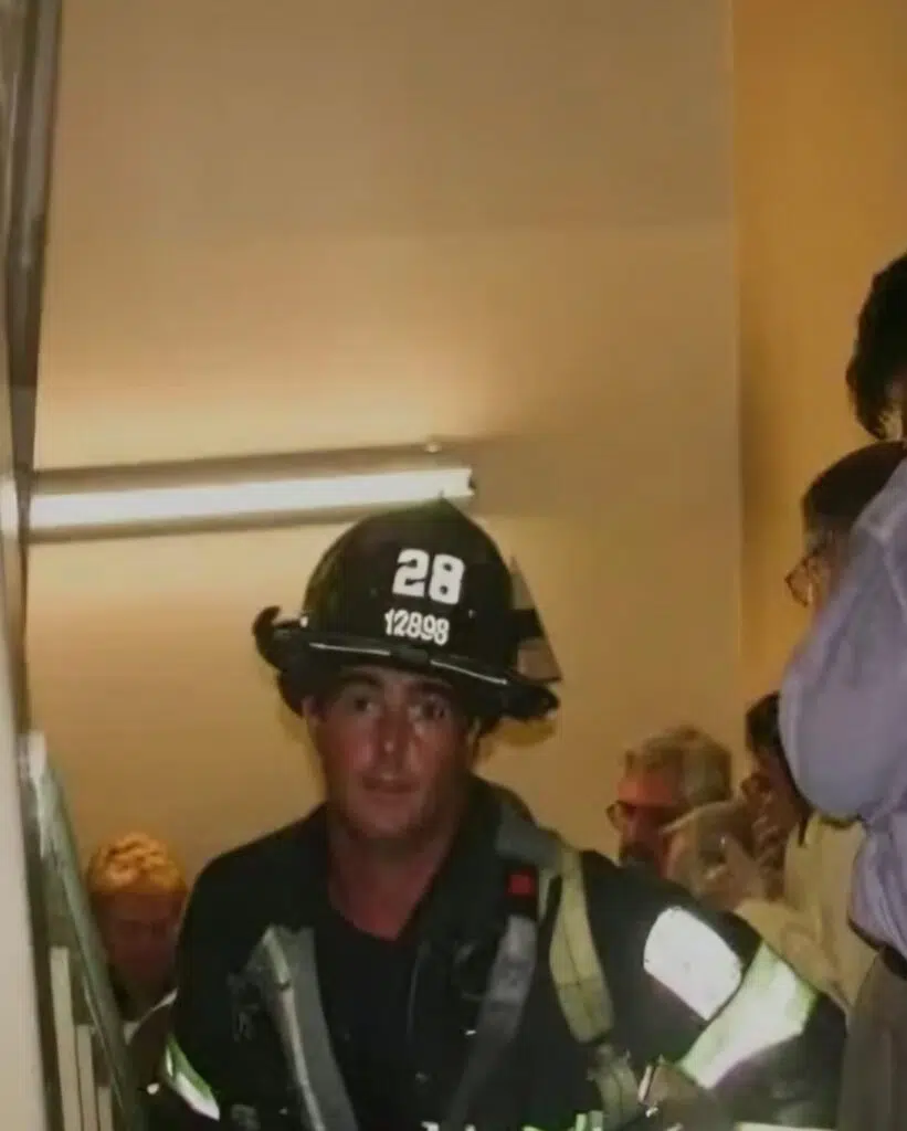 image from inside the twin towers during the attack of a firefighter saving civilians 