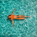woman swimming alone in body of water